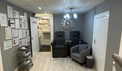 Grey interior with bright white lighting and a fashionable clock on the wall.