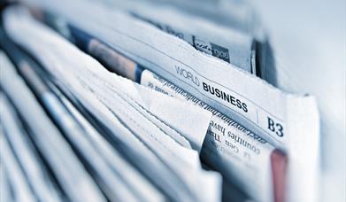 newspapers in a stack.