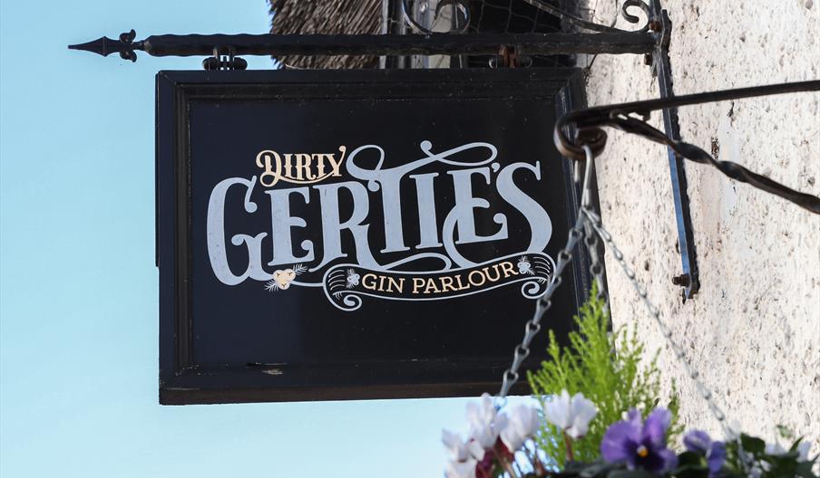 Dirty Gerties sign in black, white and gold