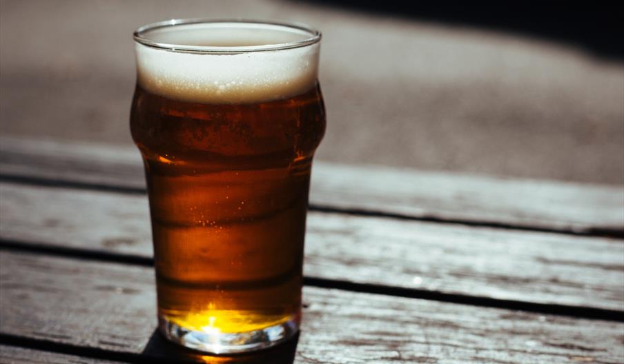 Pint of ale on a wooden table top