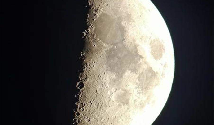 Moon in shadow against a dark sky