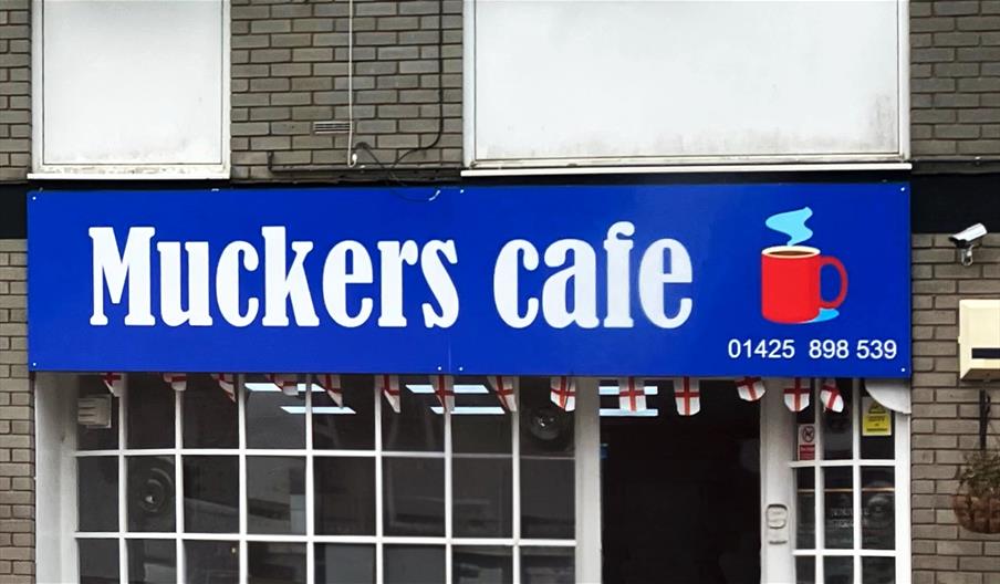 Cafe Exterior, featuring a large blue sign.