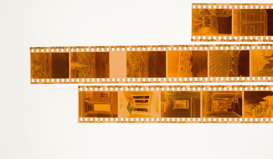 Strips of photographic negatives showing buildings and street scenes
