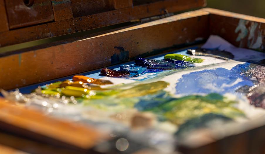 Palette with paint on, in various colours