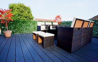 Outdoor seating area with wooden flooring