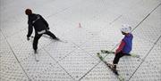 Instructor teaching a child the correct skiing technique