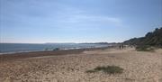 Highcliffe beach on a sunny day looking west towards Poole and Bournemouth.