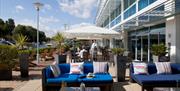 Outside seating and parasols on the Captains Club Terrace.