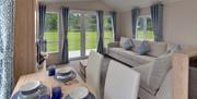beautifully decorated dining room and living room with light decor Meadowbank Holidays