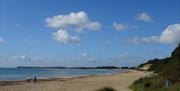 A couple of people out on the beach looking west toward Poole and Bournemouth.
