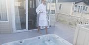Guest about to enjoy a dip in their private Jacuzzi at the holiday park