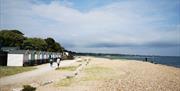 Wide shot of people walking on the dusty promenade at Avon Beach.