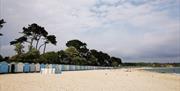 Wide shot of Avon Beach huts stretching out towards Highcliffe beach in the East.