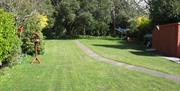Garden with green grass and trees surrounding the garden