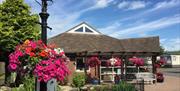 reception on a beautiful bright day with flowering hanging baskets