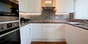 Light modern kitchen with appliances