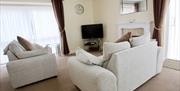 Warm open lounge with TV and fire place