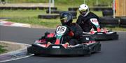 Two people raceing each other in go karts