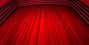 Red velvet curtains covering the cinema screen