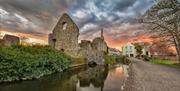 The Norman House photographed with a wide angle during a cloudy sunset.