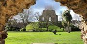The Castle Ruins photographed through a doorway of the Norman House.